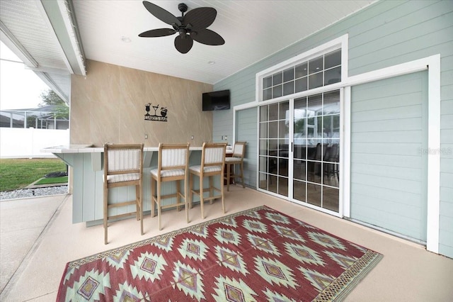 view of patio featuring ceiling fan and fence