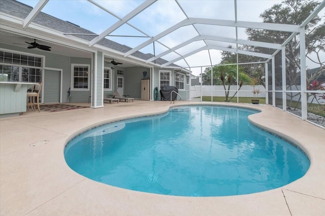 view of pool with fence, outdoor dry bar, a fenced in pool, and a patio