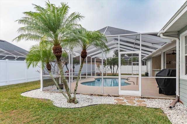 view of pool featuring a fenced backyard, a lanai, a yard, grilling area, and a fenced in pool