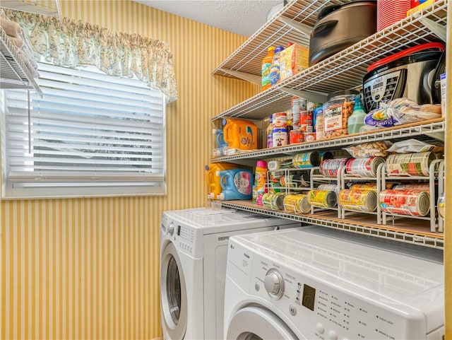 washroom with separate washer and dryer and a textured ceiling