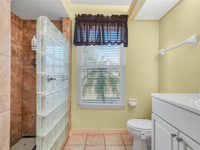 bathroom with vanity, tile patterned flooring, plenty of natural light, and tiled shower