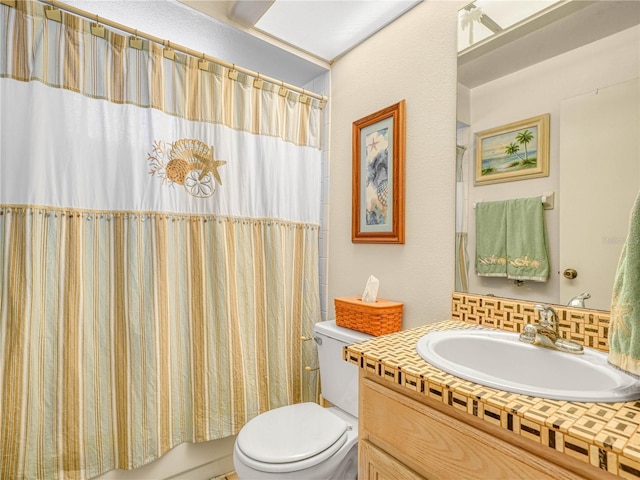 full bathroom with vanity, toilet, and shower / tub combo with curtain