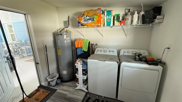 laundry room featuring hardwood / wood-style floors, washing machine and dryer, and electric water heater