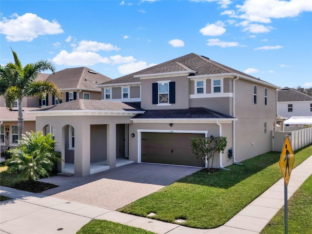 view of front of property with a garage and a front yard