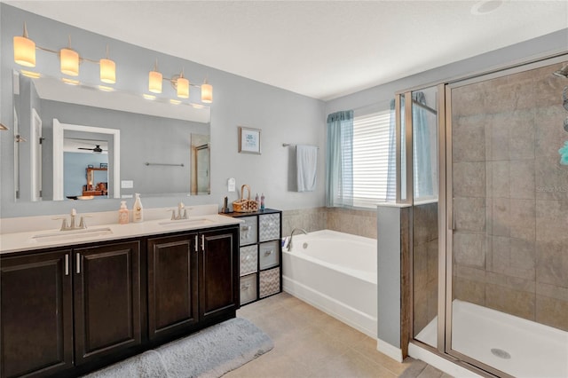 bathroom featuring vanity, tile patterned flooring, and separate shower and tub