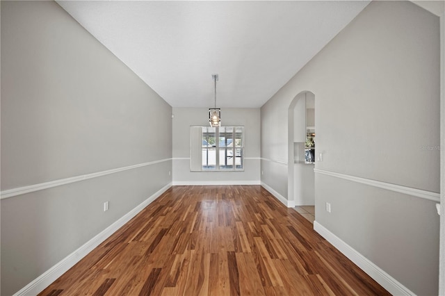 unfurnished dining area featuring dark hardwood / wood-style flooring