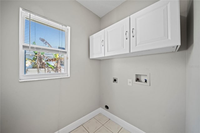 clothes washing area with cabinets, electric dryer hookup, and washer hookup