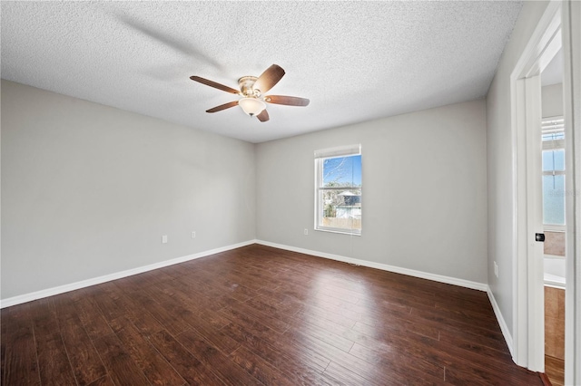 unfurnished room with ceiling fan, dark hardwood / wood-style flooring, and a textured ceiling