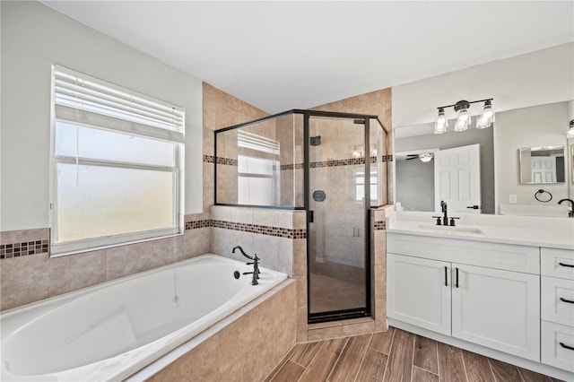 bathroom featuring vanity and separate shower and tub