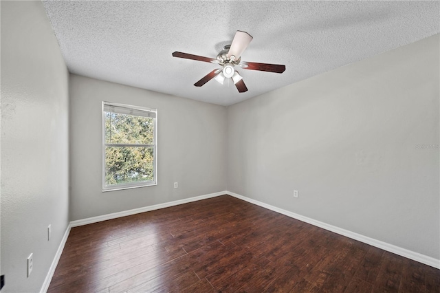 spare room with ceiling fan, dark hardwood / wood-style floors, and a textured ceiling