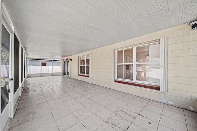 unfurnished sunroom with wood ceiling