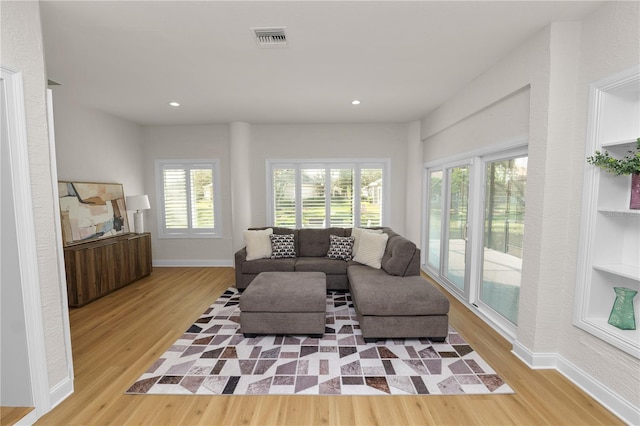 living room featuring plenty of natural light and light hardwood / wood-style floors