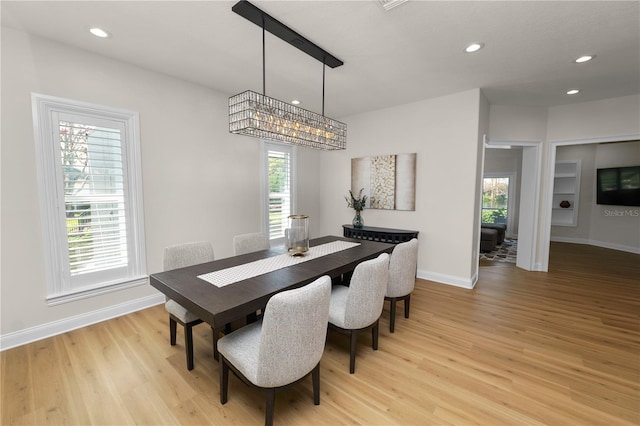 dining area with a wealth of natural light and light wood-type flooring