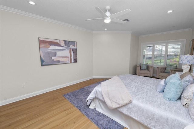 bedroom featuring hardwood / wood-style flooring, ceiling fan, and ornamental molding