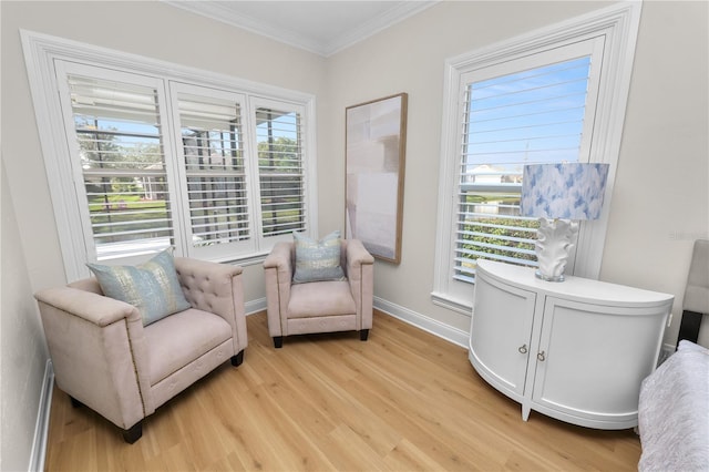 sitting room with crown molding and light wood-type flooring