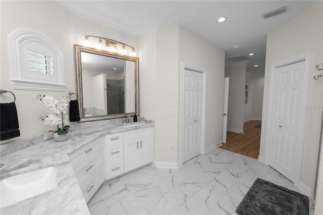 bathroom featuring vanity and a shower with door