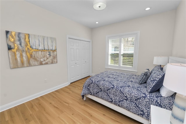 bedroom with wood-type flooring and a closet