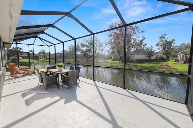 view of patio / terrace featuring a water view and a lanai