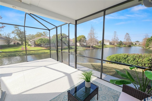 unfurnished sunroom featuring a water view