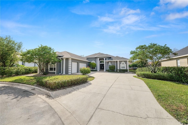 ranch-style house with a garage and a front lawn