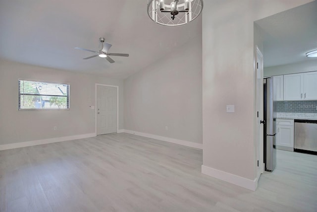 unfurnished living room featuring lofted ceiling, ceiling fan with notable chandelier, and light wood-type flooring