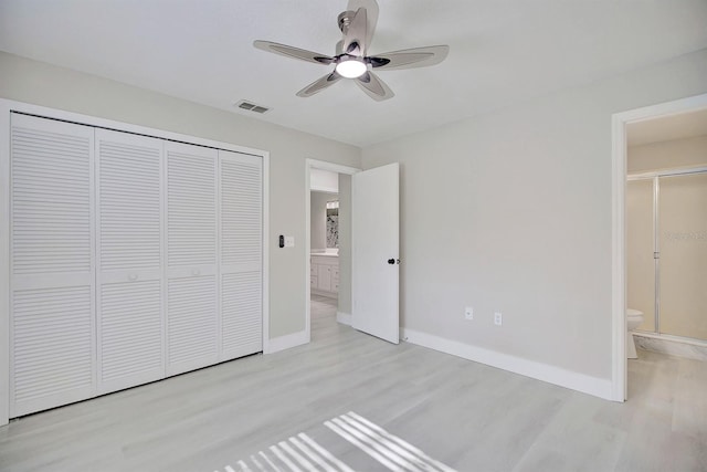 unfurnished bedroom with ceiling fan, connected bathroom, light hardwood / wood-style floors, and a closet