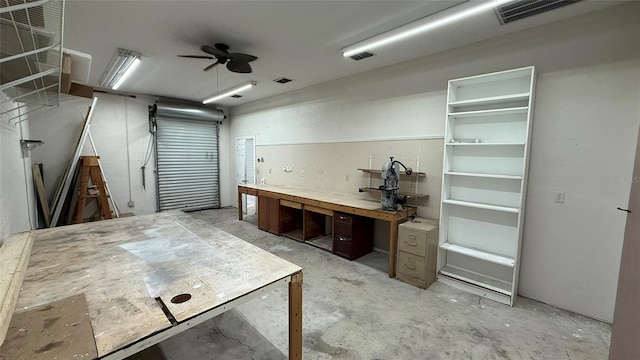 garage with ceiling fan and a workshop area