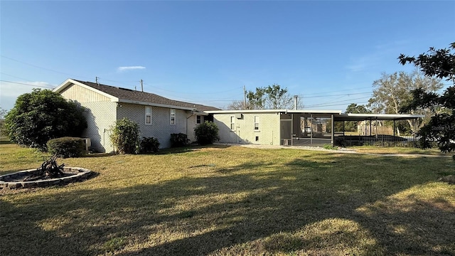 view of yard with a carport and a sunroom