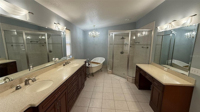 bathroom featuring tile patterned floors, shower with separate bathtub, a chandelier, and a textured ceiling