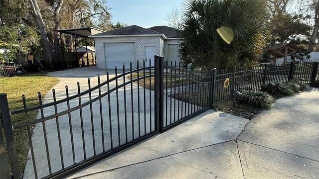 view of gate with an outbuilding