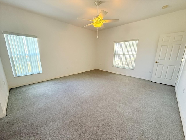 empty room featuring light colored carpet and ceiling fan