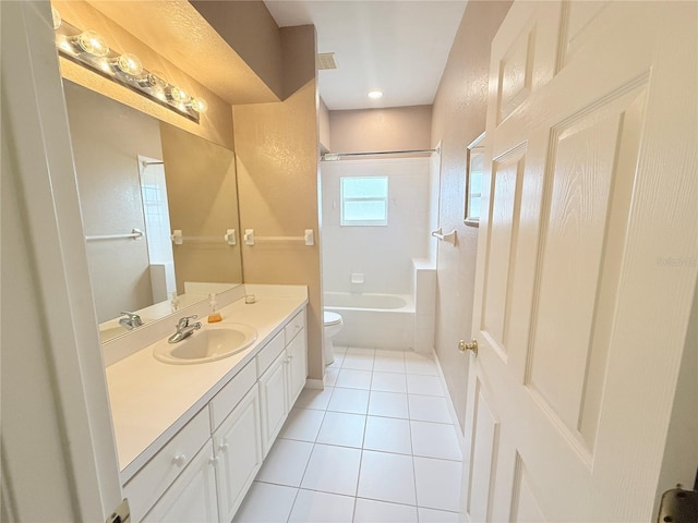 full bathroom with tile patterned floors, toilet, tiled shower / bath combo, and vanity