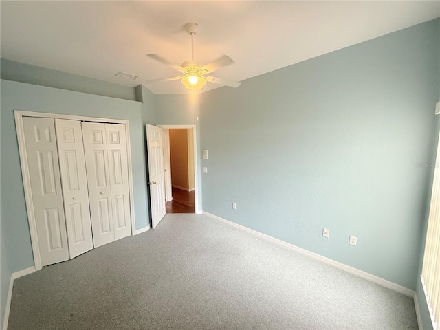 unfurnished bedroom featuring ceiling fan, a closet, and carpet