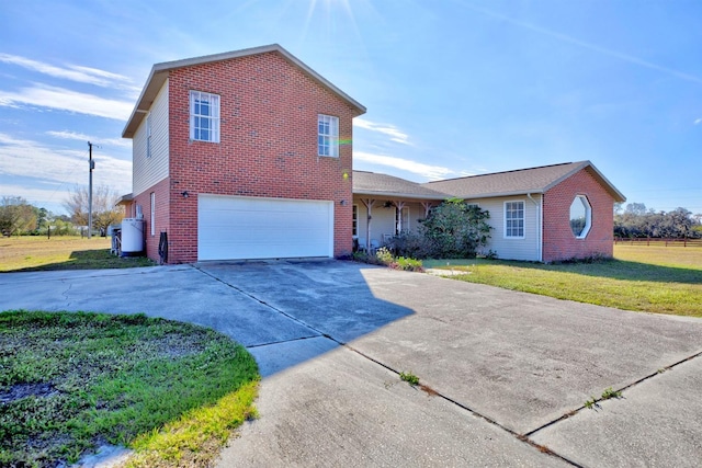 view of front of property with a garage and a front yard