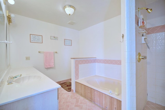 bathroom with vanity and independent shower and bath