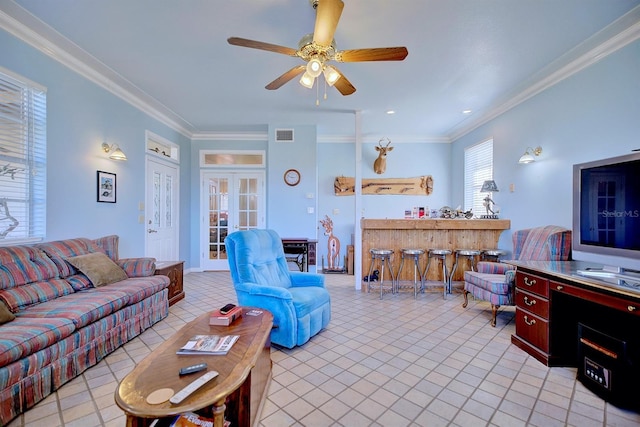 living room with light tile patterned floors, ornamental molding, and french doors