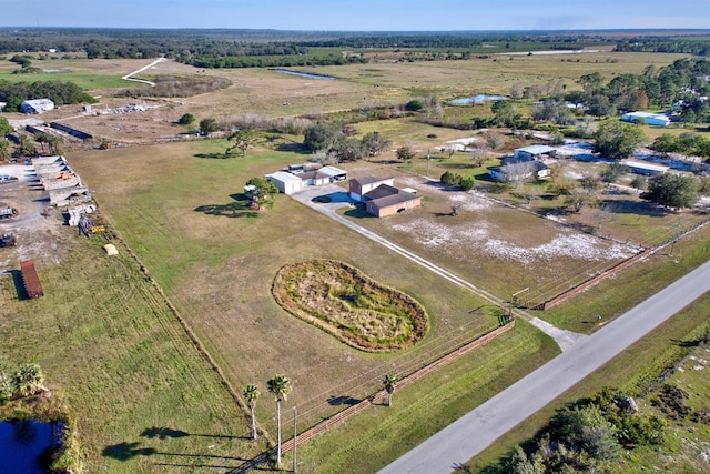 birds eye view of property featuring a water view and a rural view