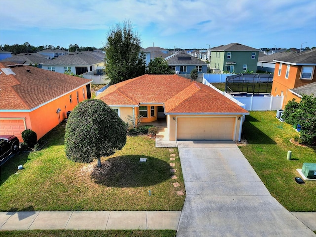 view of front of home with a garage and a front lawn