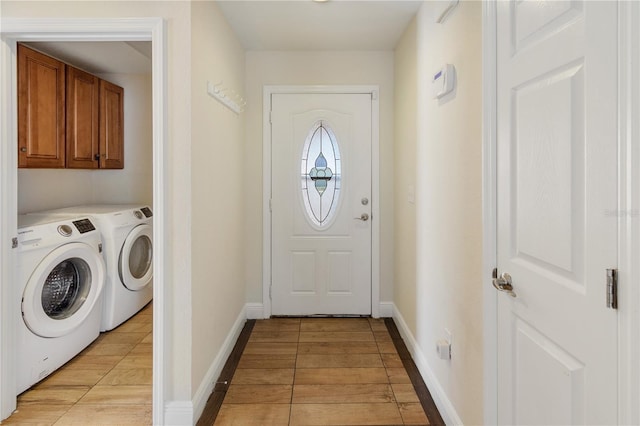 laundry area featuring cabinets, light hardwood / wood-style floors, and washer and dryer