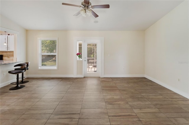 interior space with ceiling fan