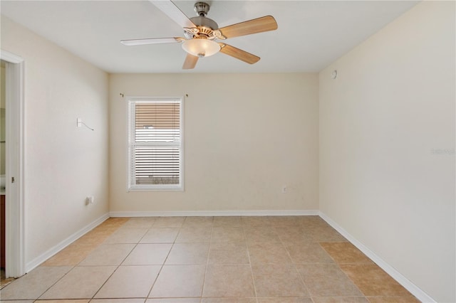 tiled spare room featuring ceiling fan