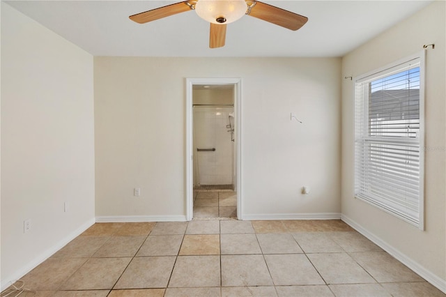 tiled empty room with ceiling fan