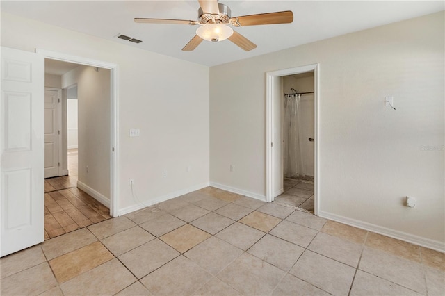 tiled empty room with ceiling fan