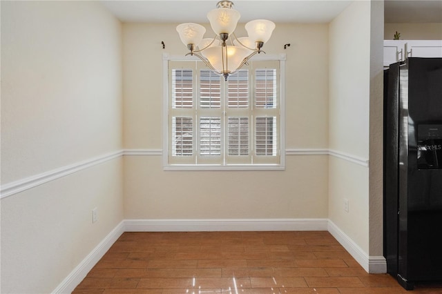 unfurnished dining area featuring wood-type flooring and a chandelier