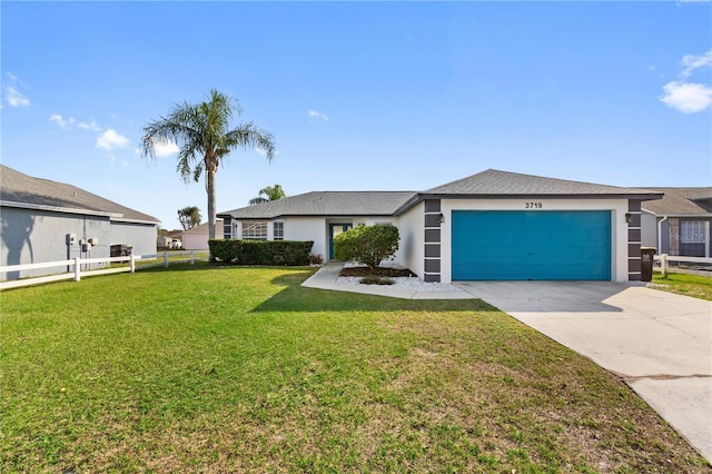 view of front of home featuring a garage and a front lawn