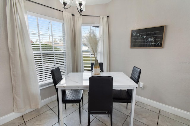 dining space with light tile patterned floors and a chandelier