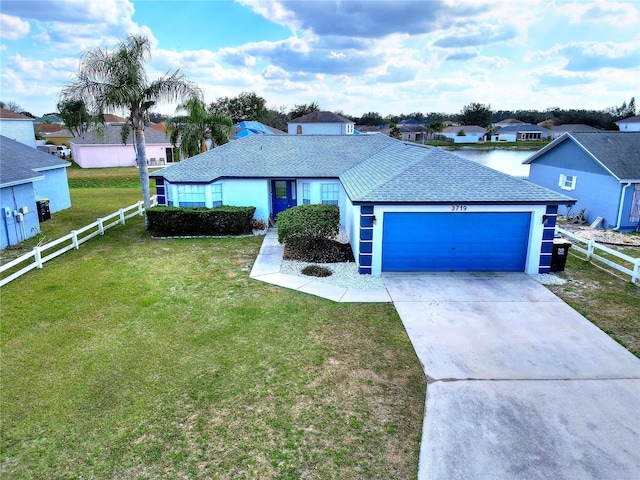 ranch-style house with a garage and a front lawn