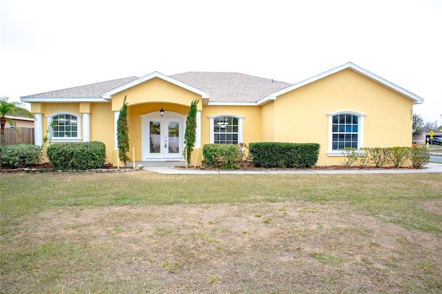 ranch-style home featuring a front lawn and french doors