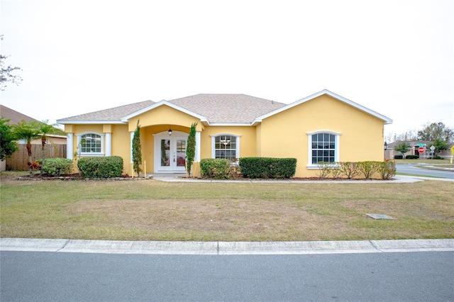 single story home with a front yard and french doors