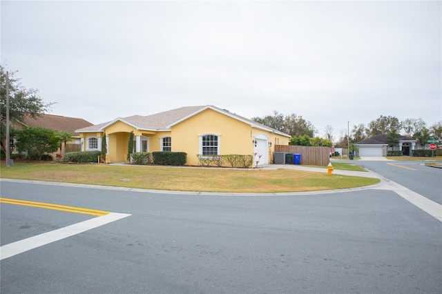 view of front of home with a garage and a front yard